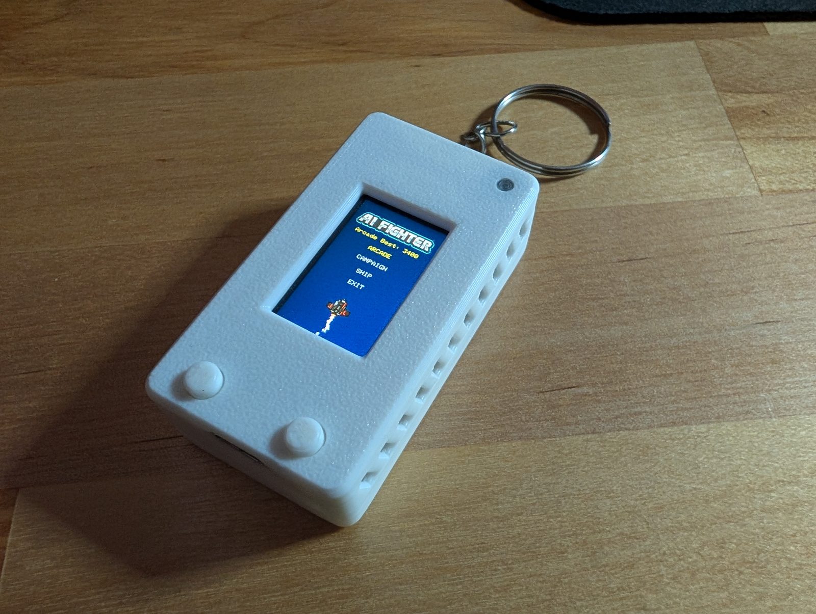 White 3D-printed Kivo handheld running a game