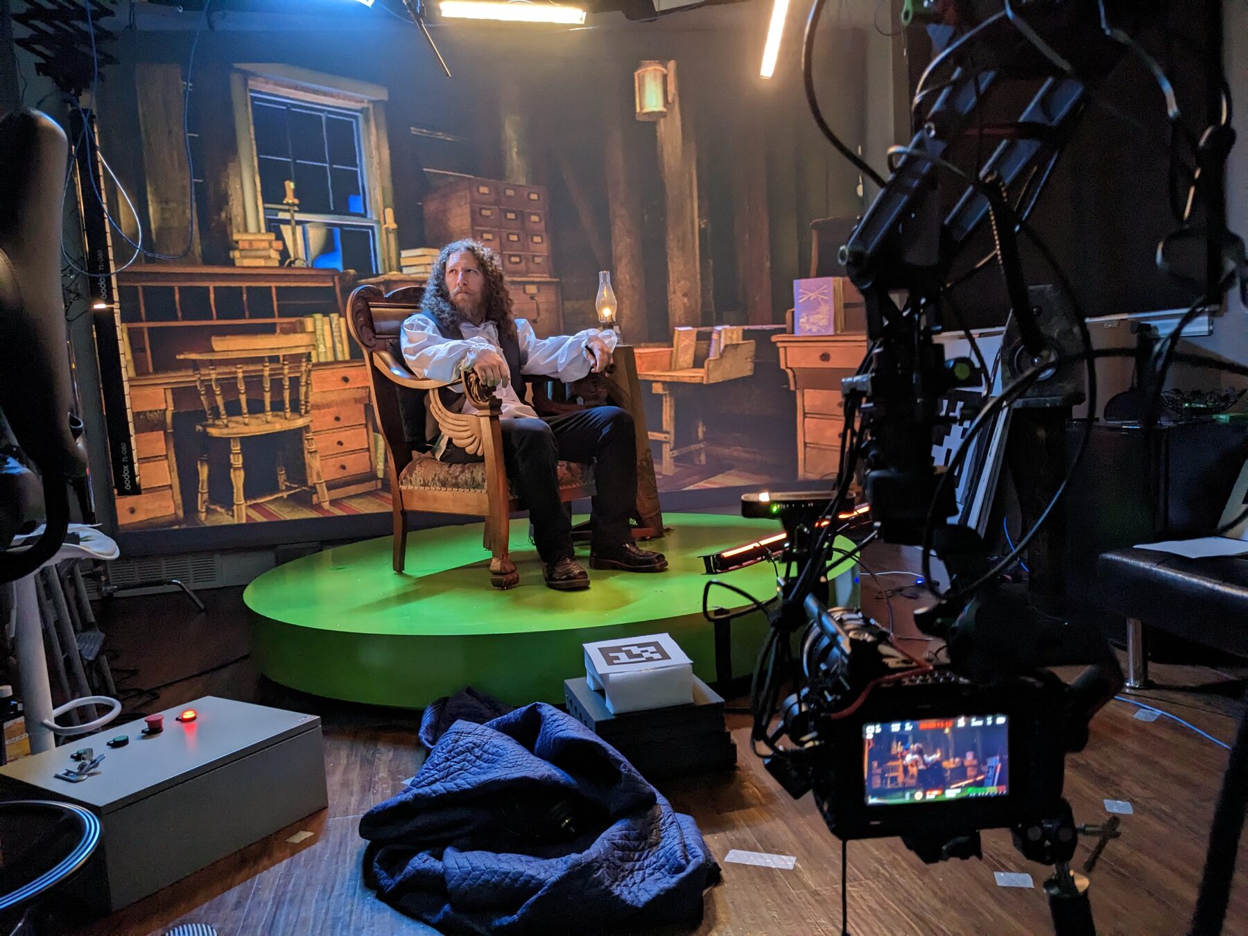 Actor on a lit turntable during a virtual production shoot
